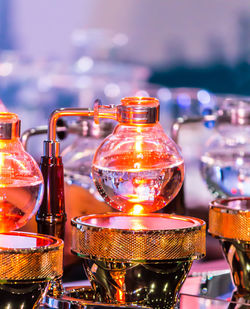 Close-up of lit candles on table