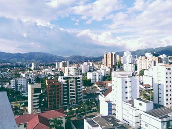 Cityscape against cloudy sky