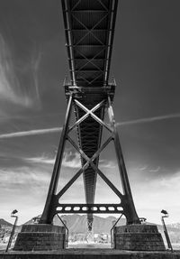 Low angle view of cranes against sky