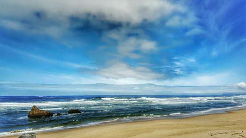 Scenic view of sea against cloudy sky