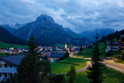 Town by mountain against sky