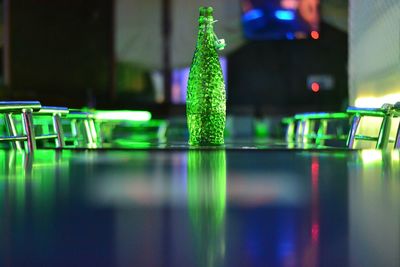 Close-up of beer bottle on table in bar