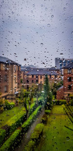 Raindrops on glass window of rainy season