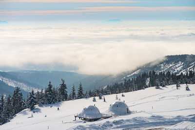 Scenic view of snow covered mountains against sky