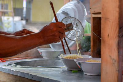 Cropped hands preparing food