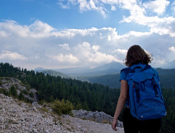 Rear view of woman looking at mountain against sky