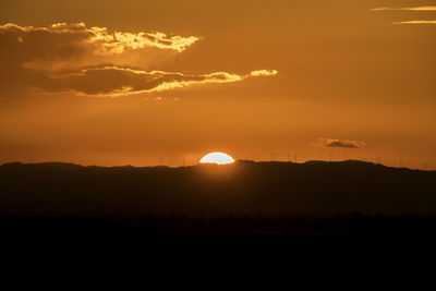 Scenic view of silhouette landscape against romantic sky at sunset