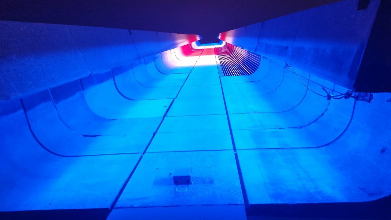 HIGH ANGLE VIEW OF ILLUMINATED SWIMMING POOL