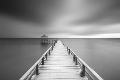 Pier over sea against sky