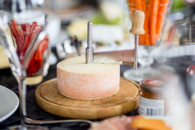 Cheese with slicer on cutting board