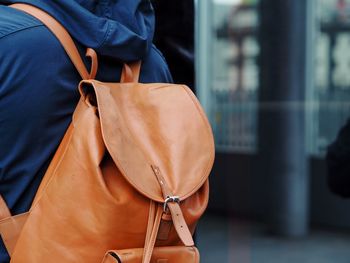 Rear view of woman holding mobile phone