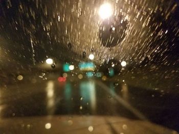 Defocused image of wet car window at night