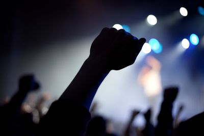 Close-up of hand holding camera at music concert