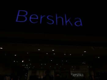 Low angle view of illuminated sign at night