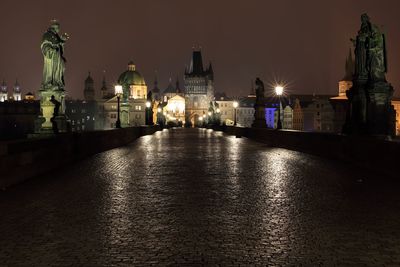 Illuminated charles bridge in city at night