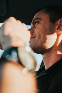 Low angle view of man sitting in car