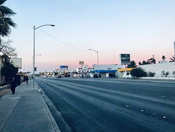 City street against sky during sunset