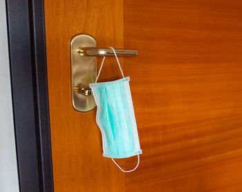 Close-up of clothes hanging on wooden door