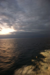 Scenic view of sea against cloudy sky