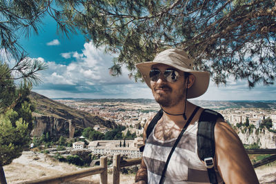 Tourist man with hat and sunglasses in the city of cuenca