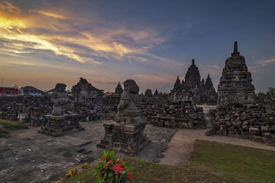 Temple against buildings at sunset