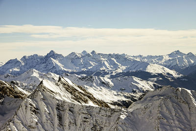 Scenic view of snow covered mountains against sky