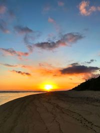 Scenic view of beach against sky during sunset