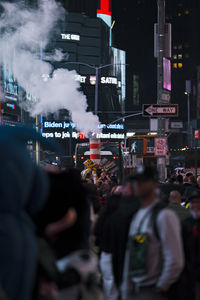 Rear view of people in city at night