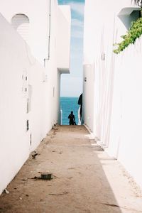 Full length of woman walking in narrow alley