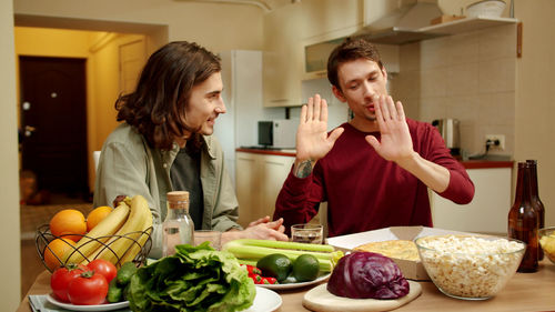 Young couple preparing food in kitchen at home