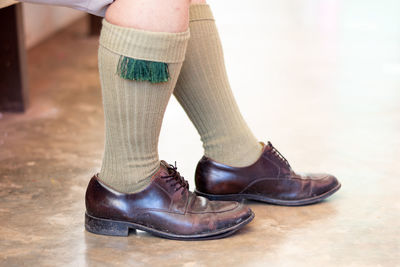 Low section of man wearing shoes standing outdoors