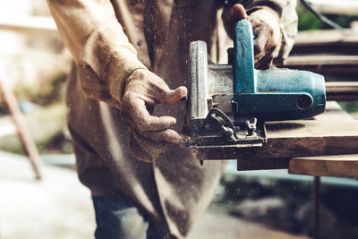 Close-up of man working on metal