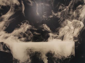 Close-up of smoke emitting from black background