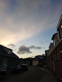 Buildings in city against cloudy sky