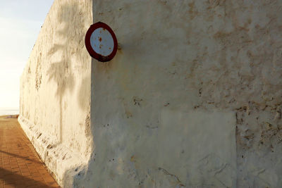 Low angle view of clock on wall