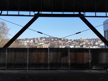 Railroad station by town against clear blue sky