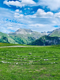Scenic view of field and mountains against sky