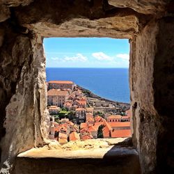 Scenic view of sea against sky seen through window