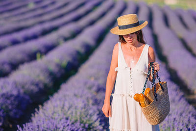 Close-up of woman standing on lavender amidst plants