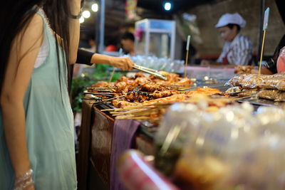 Midsection of woman at market stall