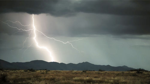 Lightning storm over city in purple light