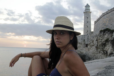 Portrait of beautiful woman on beach against sky