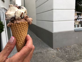 Close-up of hand holding ice cream cone