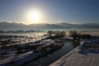 Scenic view of snow covered landscape during sunset