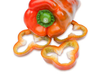 Close-up of red bell peppers against white background