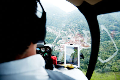 Rear view of man traveling in bus