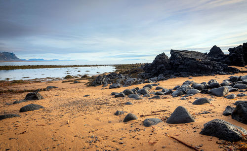 Rocks on beach against sky