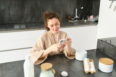 Young woman drinking coffee at home