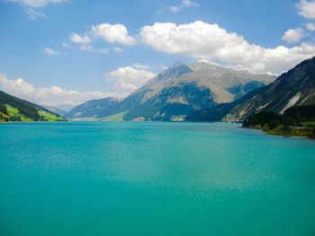 Scenic view of lake and mountains against sky