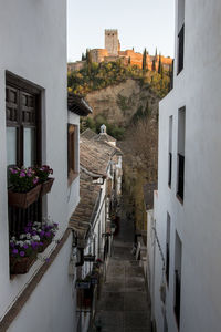 Alley amidst buildings in city against sky